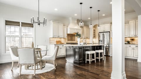Kitchen at 13429 Boxelder Court, Carmel, IN — Updated kitchen with dark island and modern finishes.