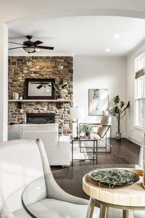Living room at 13429 Boxelder Court, Carmel, IN — Stunning stone fireplace with modern living space.