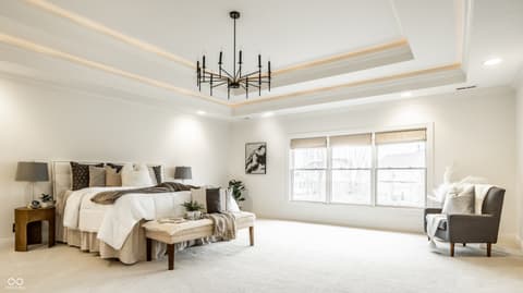 Primary bedroom at 13429 Boxelder Court, Carmel, IN — Bright primary suite with tray ceiling and abundant windows.