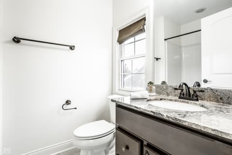 Primary bathroom at 13429 Boxelder Court, Carmel, IN — Luxurious primary bath with marble counters and dual vanity.