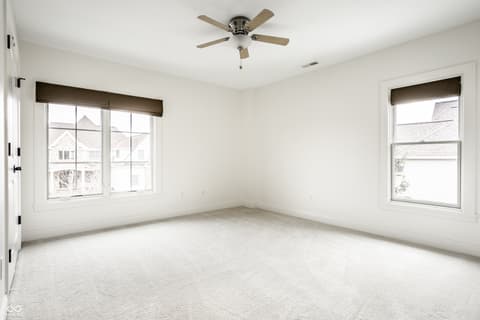 Bedroom at 13429 Boxelder Court, Carmel, IN — Bright bedroom with abundant natural light and windows.