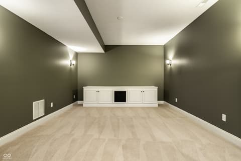 Bonus room at 13429 Boxelder Court, Carmel, IN — Spacious bonus room with built-in cabinetry and fireplace.