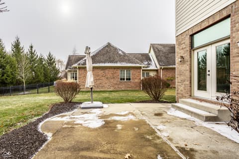 Backyard at 13429 Boxelder Court, Carmel, IN — Spacious brick home with expansive backyard and patio.