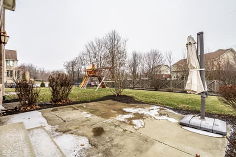 Yard at 13429 Boxelder Court, Carmel, IN — Large fenced yard with patio and play area.