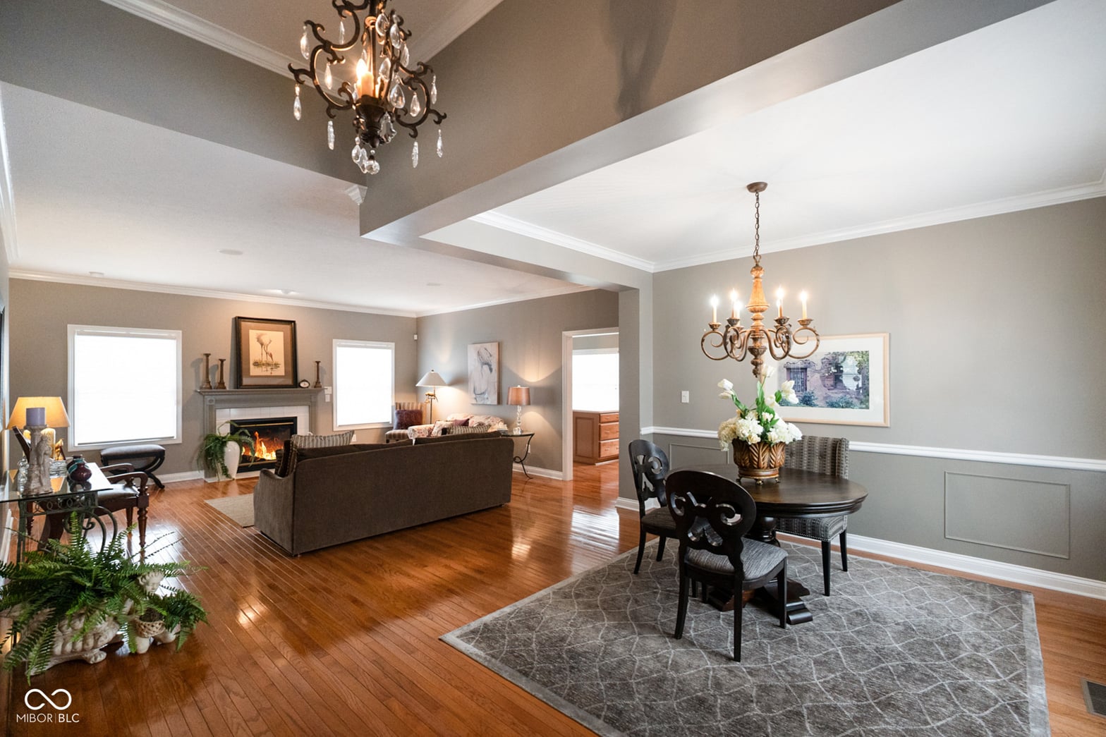 Elegant living space with fireplace and coffered ceiling.