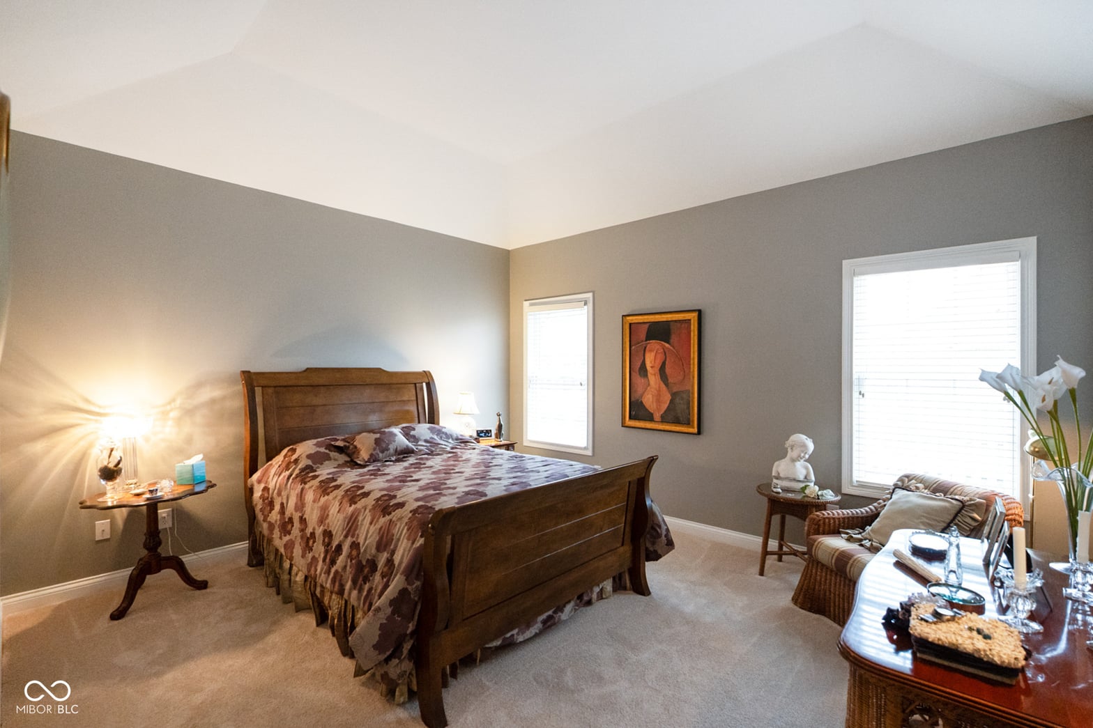 Spacious primary bedroom with abundant natural light and quality furnishings.