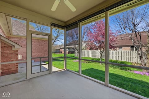 Outdoor living area at 10122 Pyrite Court, Noblesville, IN — Bright screened porch with expansive views of lush yard.