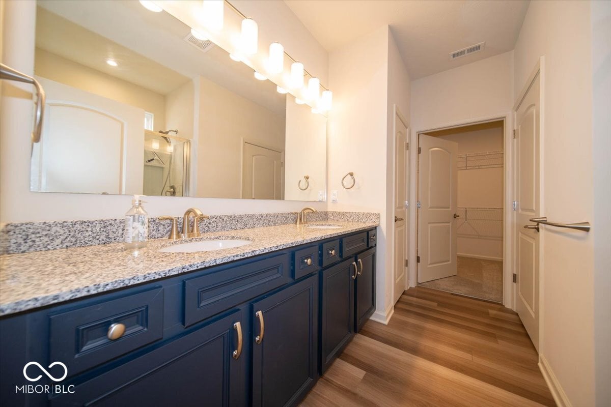 Elegant primary bath with dual vanity and granite counters.