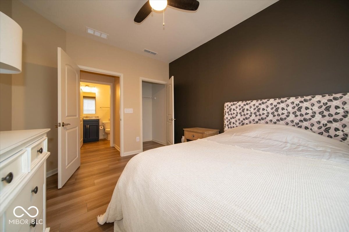 Spacious primary suite with hardwood floors and ensuite bath.