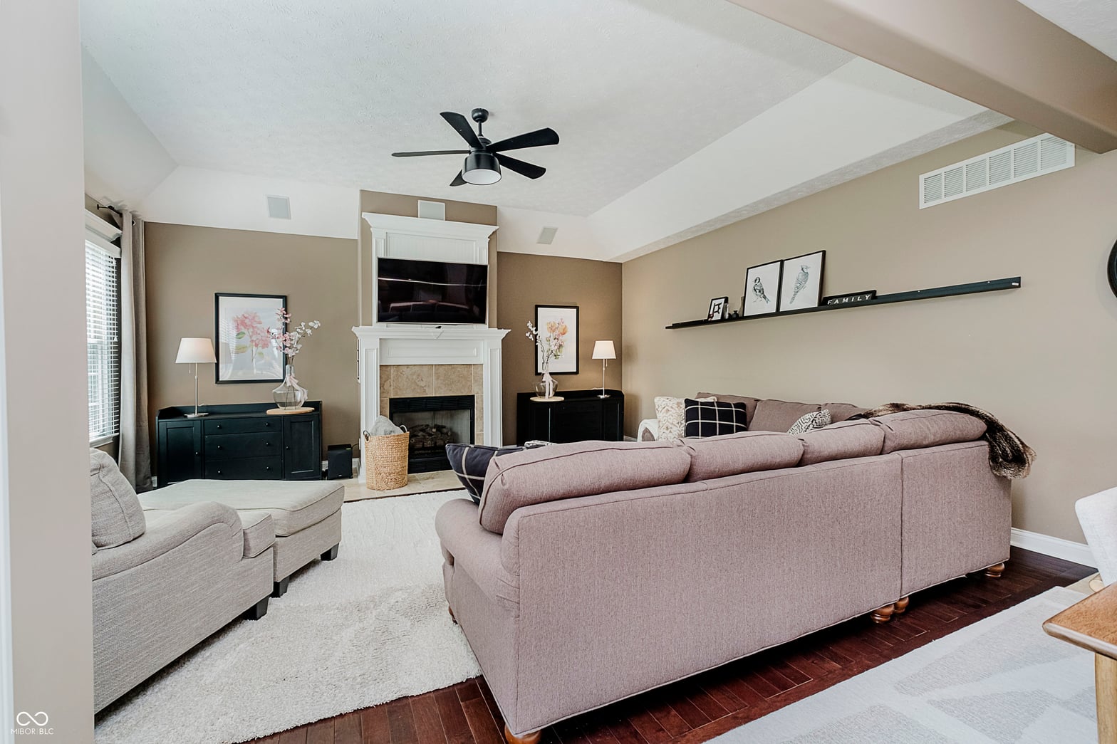 Spacious family room with fireplace and vaulted ceilings.