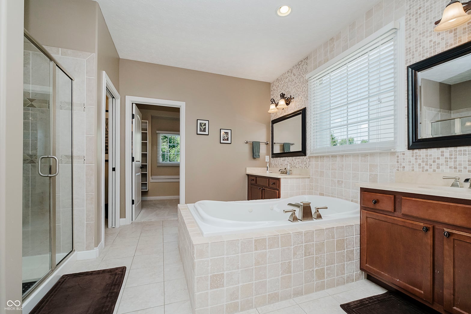 Spacious primary bath with soaking tub and walk-in shower.
