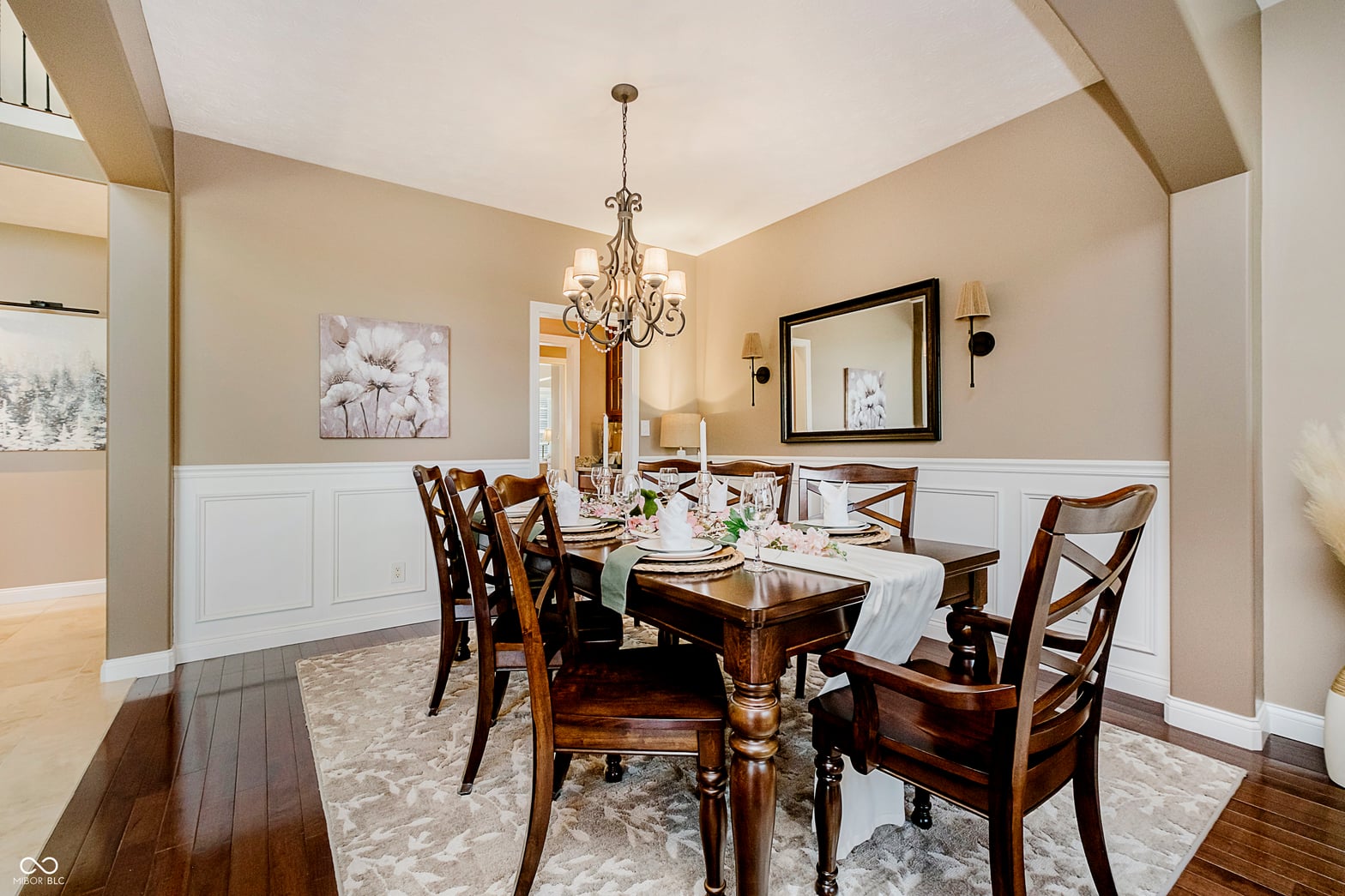 Elegant dining room with vaulted ceilings and wainscoting.