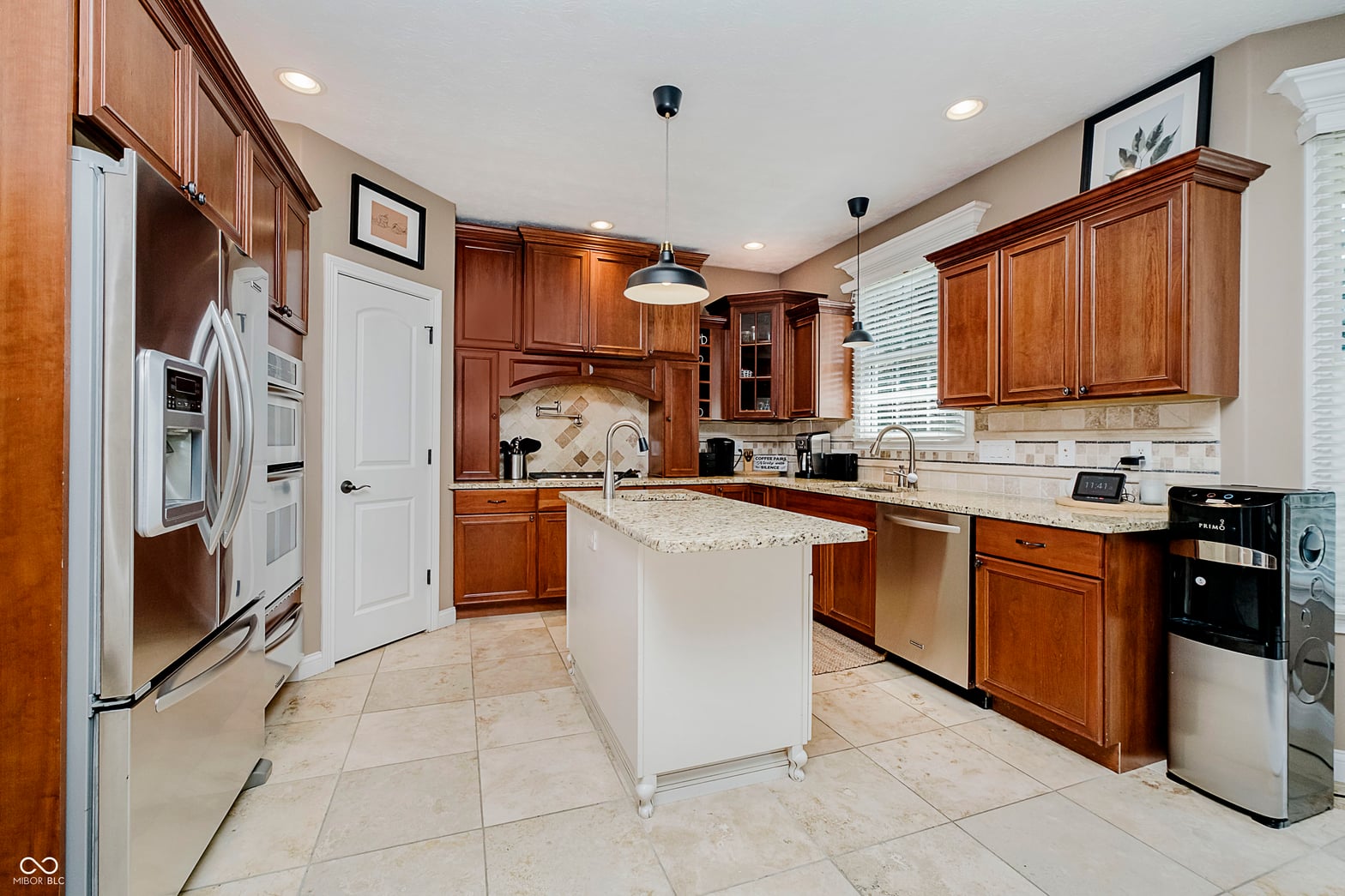 Spacious updated kitchen with granite counters and cherry wood.