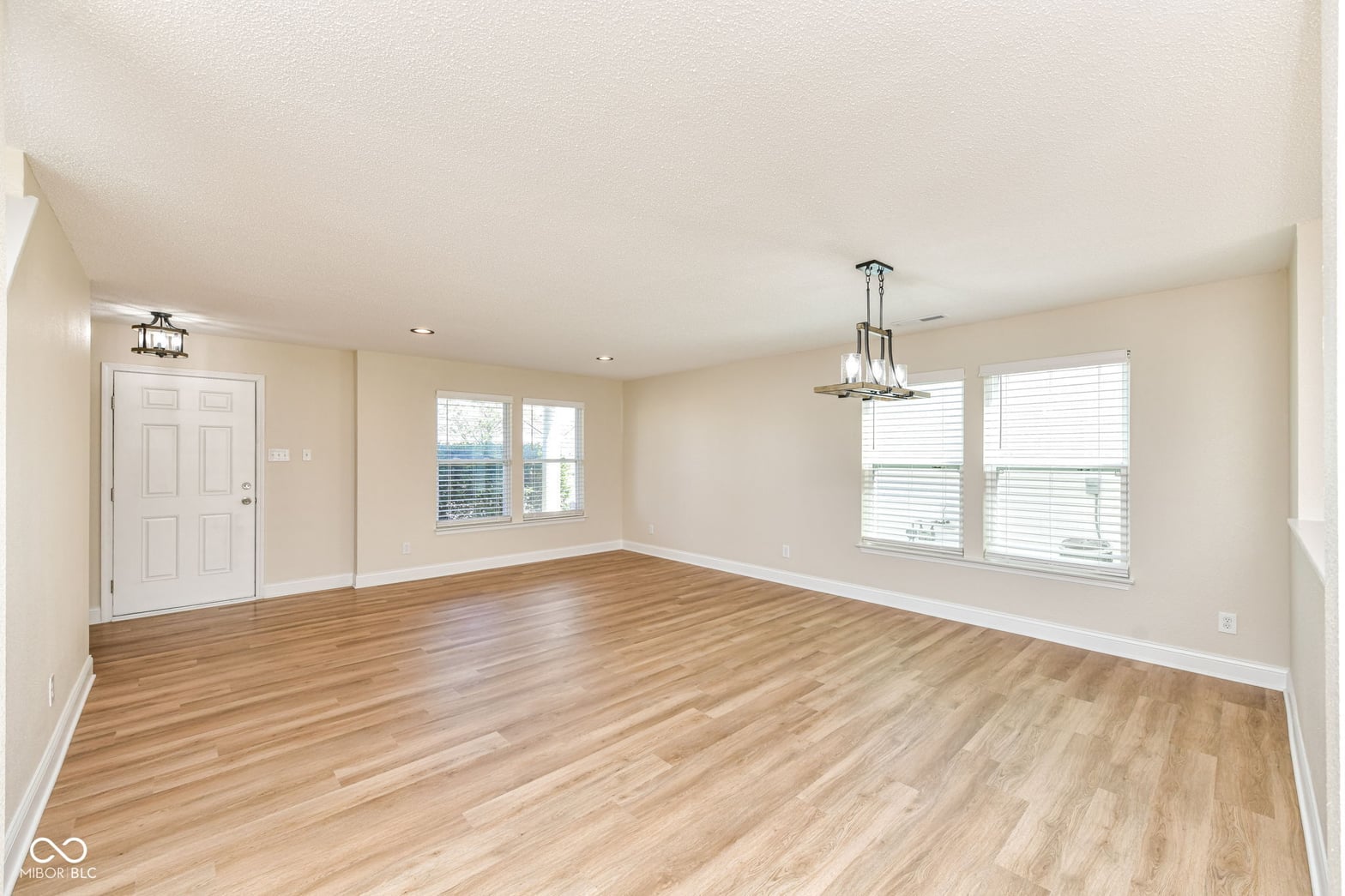 Bright, spacious living room with gleaming hardwood floors.