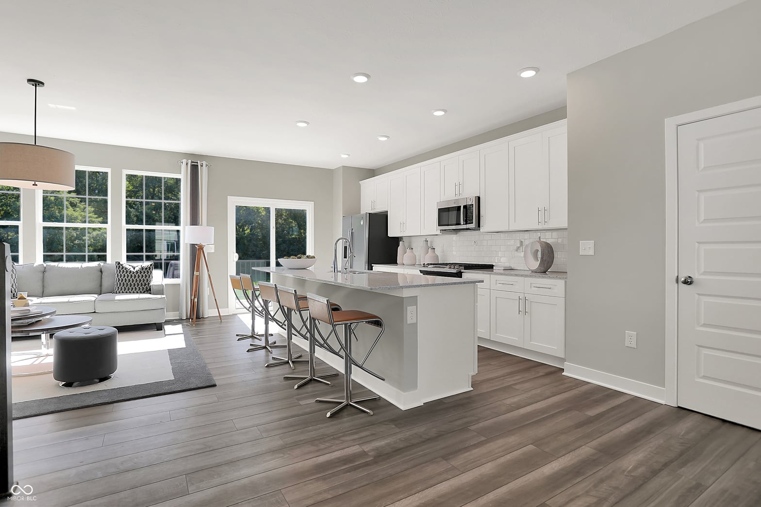 Bright contemporary kitchen with white cabinetry and island.