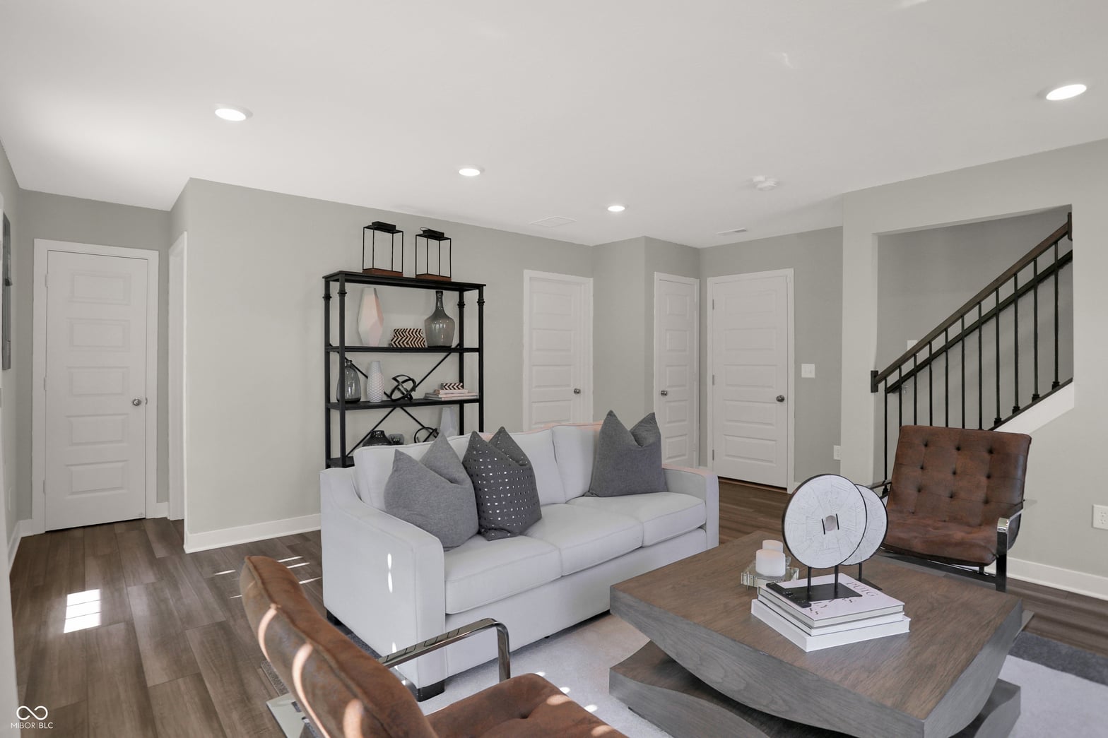 Bright, modern family room with hardwood floors and open layout.