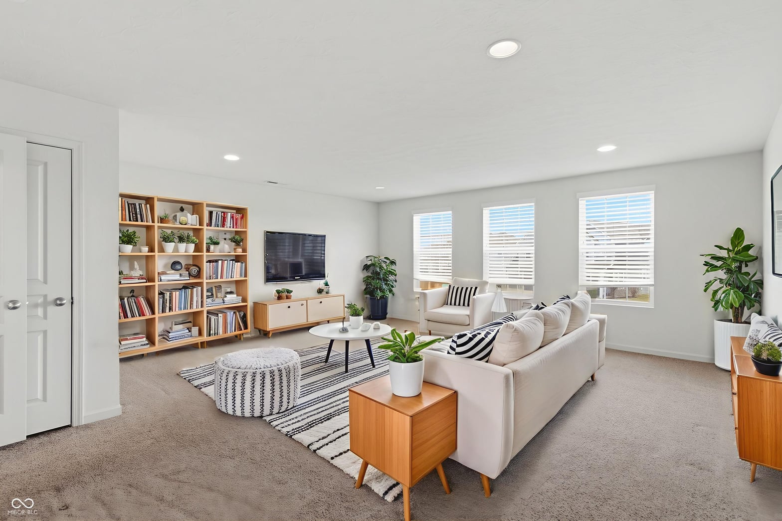 Bright family room with ample natural light and storage.