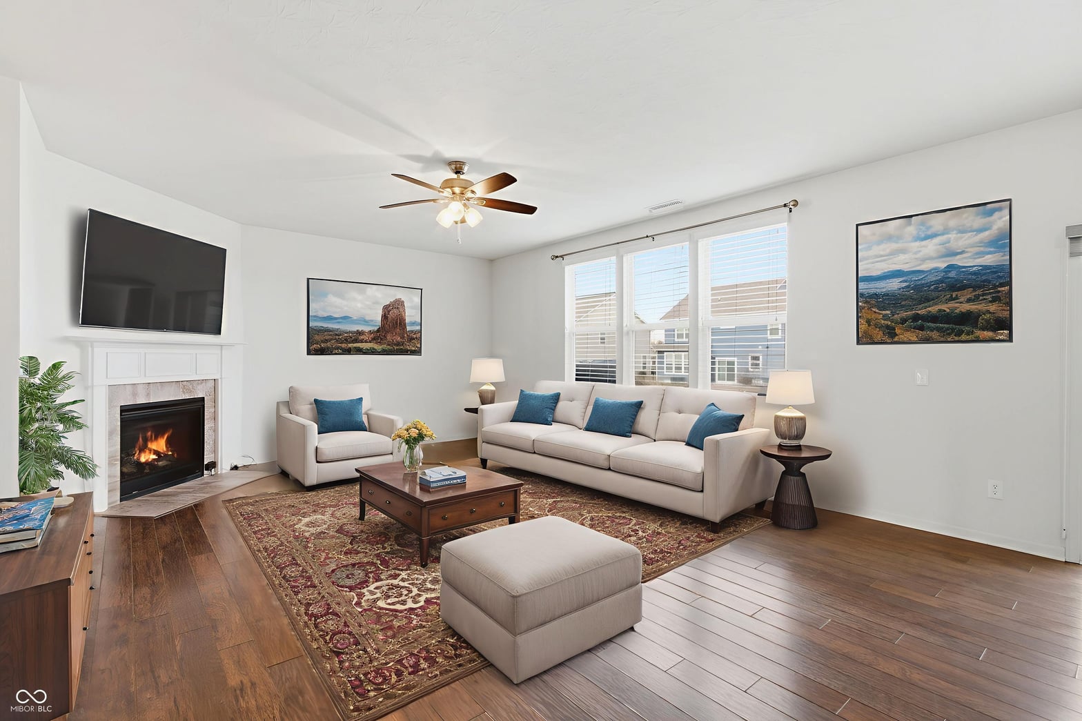 Bright living room with fireplace and expansive windows.