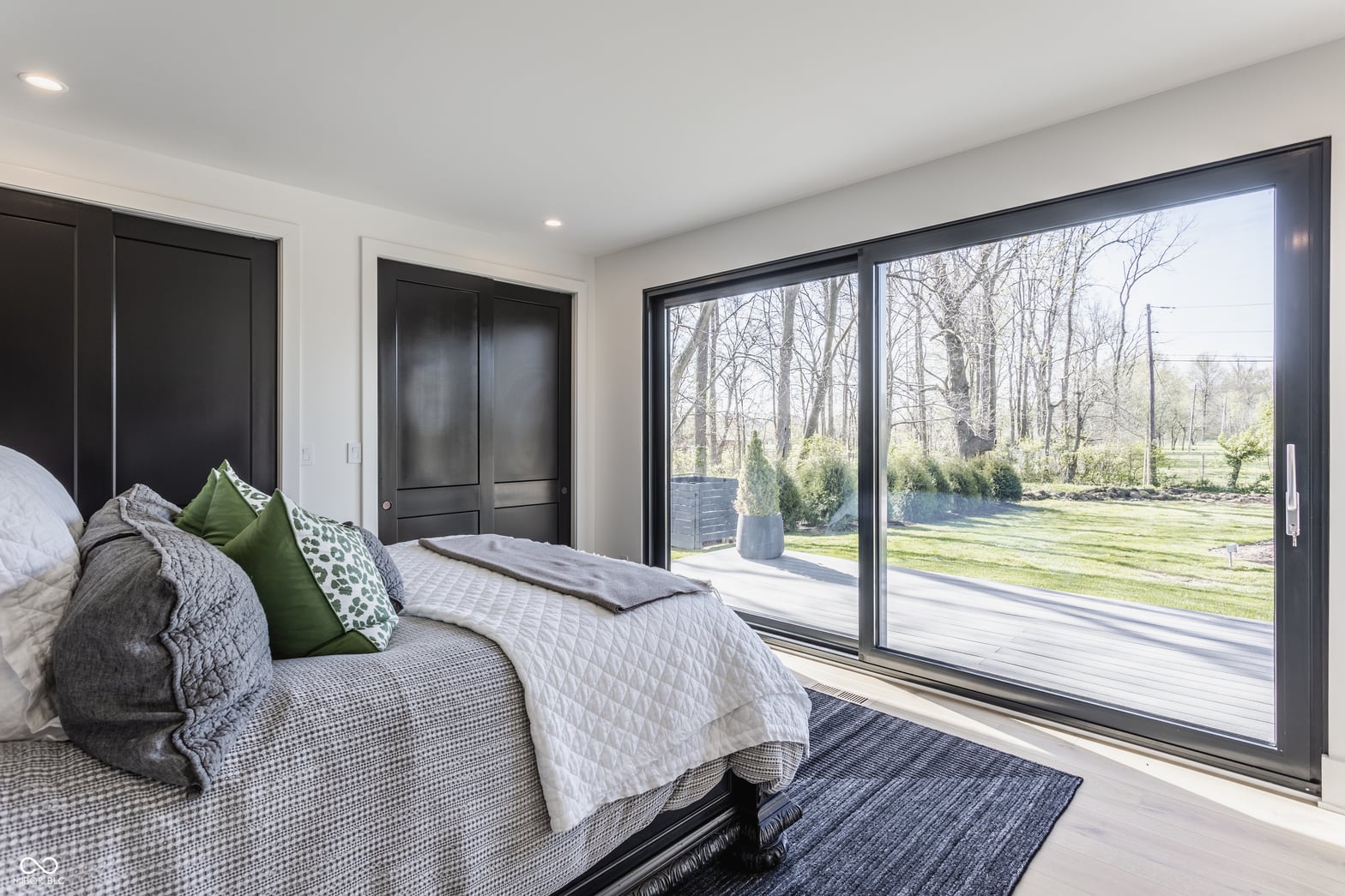 Bright primary suite with expansive yard views and modern finishes.