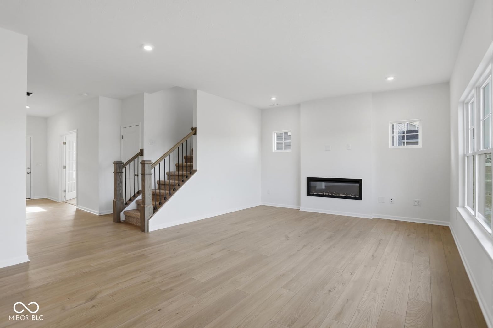 Bright contemporary living space with modern linear fireplace.