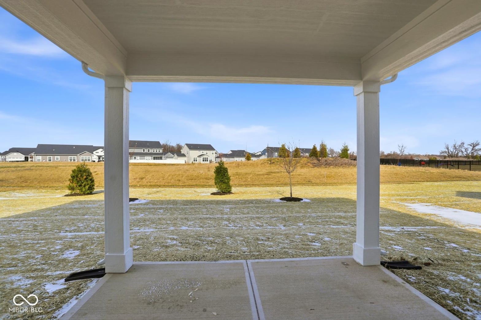 Spacious covered patio with panoramic views of open land.