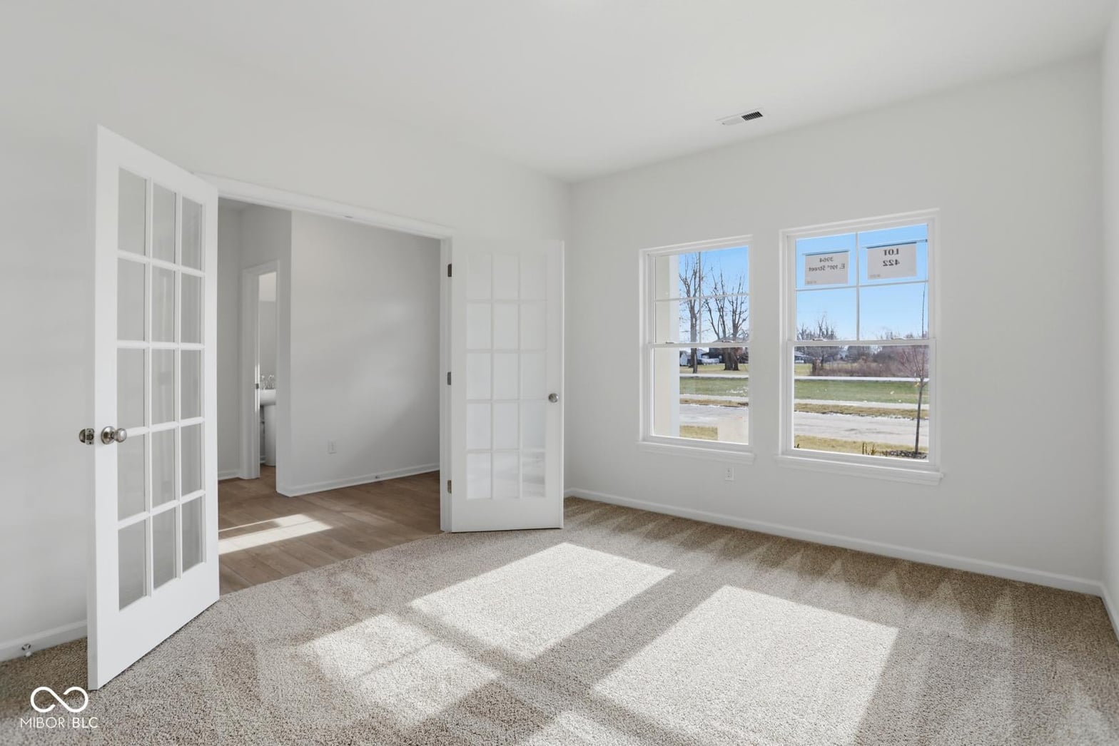 Bright primary bedroom with abundant natural light and walk-in closet.