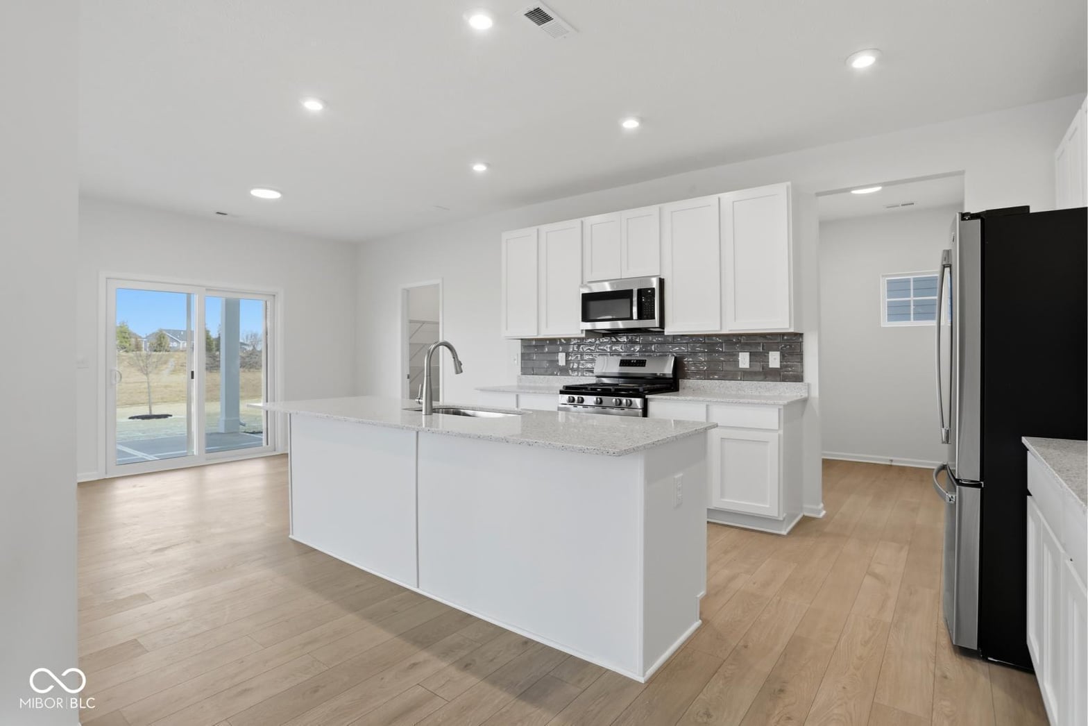 Bright modern kitchen with island and outdoor access.
