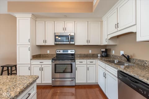 Kitchen at 20971 Shoreline Court, Noblesville, IN — Bright updated kitchen with granite and stainless steel.