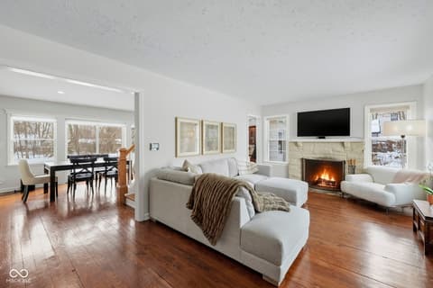 Living room at 1025 Oswego Road, Carmel, IN — Bright open living room with fireplace and winter views.
