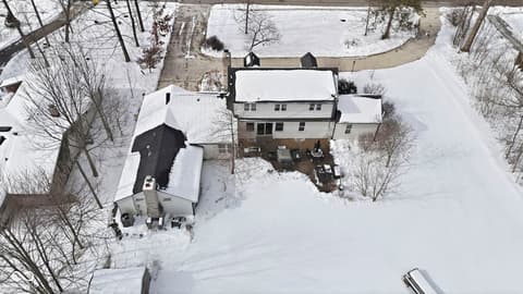 Aerial view at 1025 Oswego Road, Carmel, IN — Charming rural home on expansive wooded acreage.