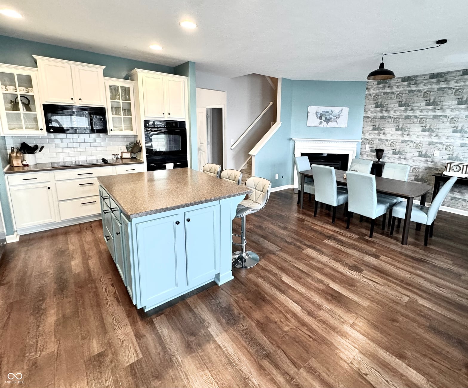 Modern renovated kitchen with bright blue island and open layout