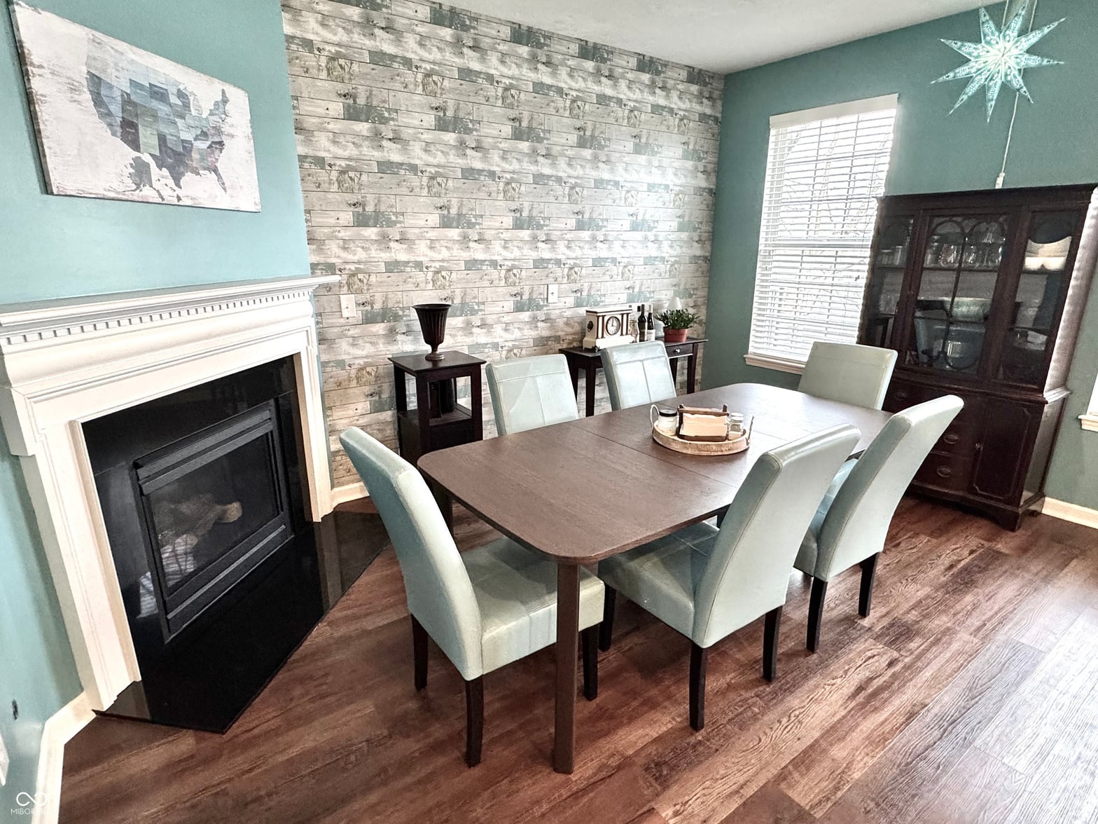Elegant dining room with fireplace and classic details.