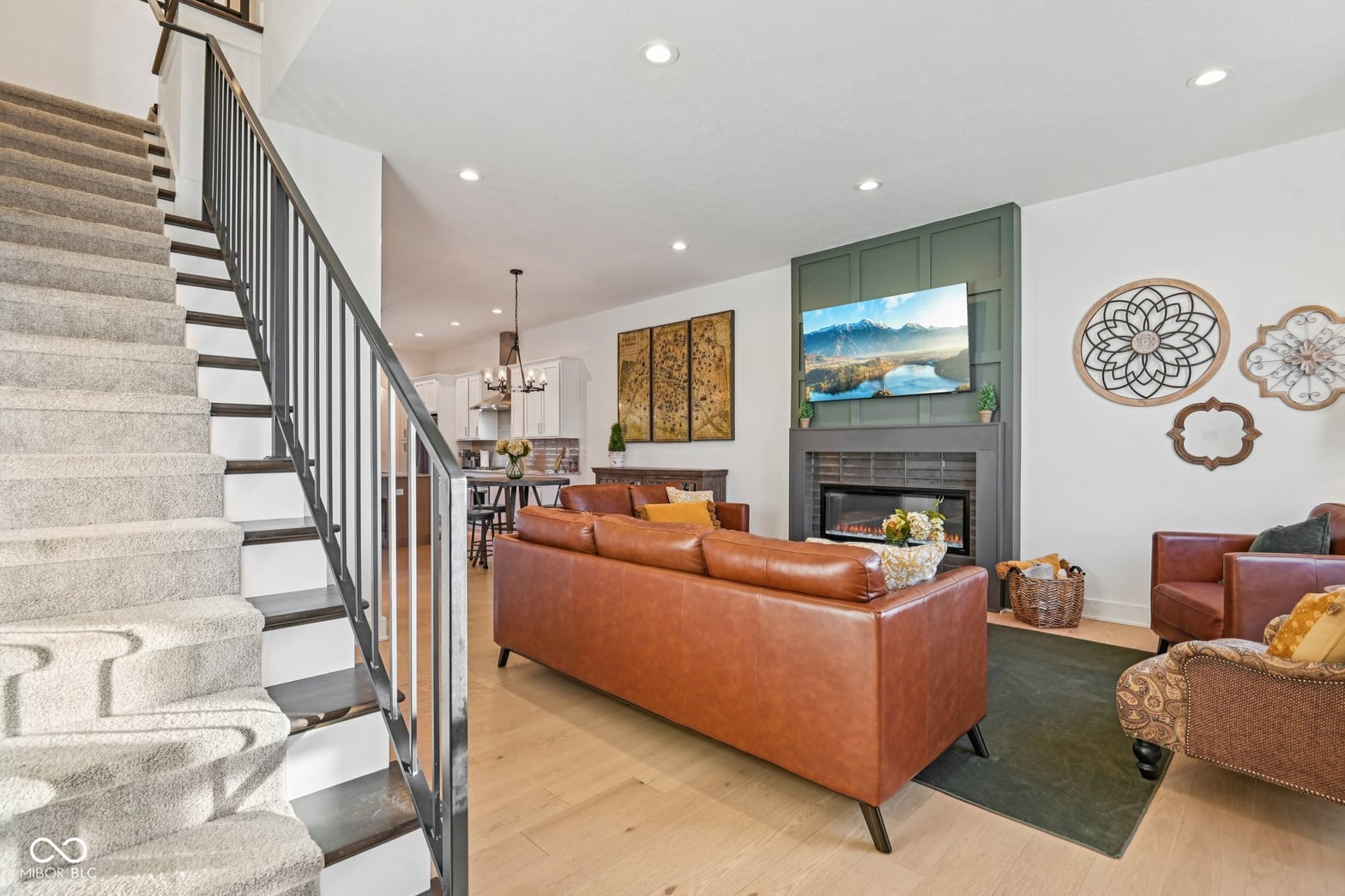 Bright contemporary living room with fireplace and modern amenities.