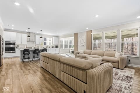 Living room at 15546 Senita Lane, Fishers, IN — Bright open-concept living space with modern kitchen.