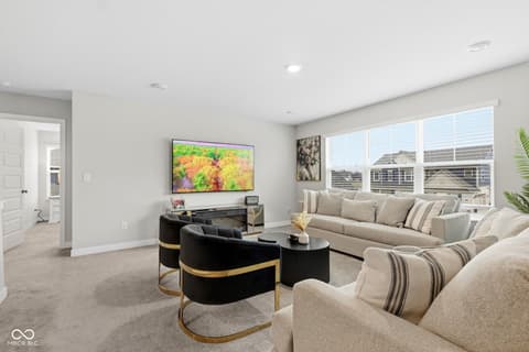 Family room at 15546 Senita Lane, Fishers, IN — Bright modern family room with extensive windows and views.