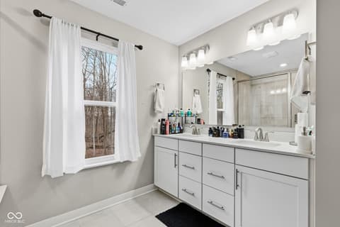 Primary bathroom at 15546 Senita Lane, Fishers, IN — Spacious primary bath with dual vanity and modern finishes.