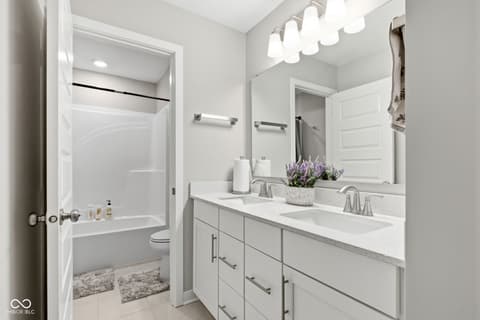 Primary bathroom at 15546 Senita Lane, Fishers, IN — Luxurious primary bath with dual vanity and separate tub.