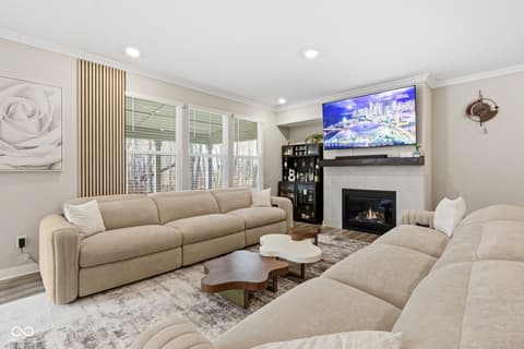 Living room at 15546 Senita Lane, Fishers, IN — Modern living room with fireplace and ample natural light.