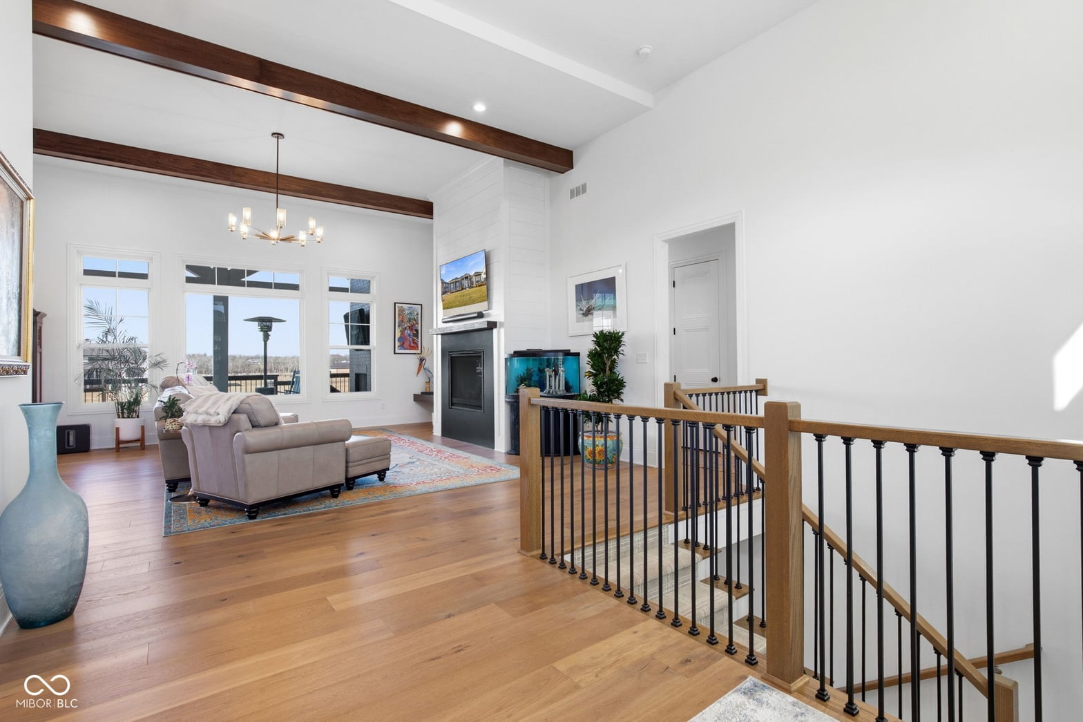 Open living space with exposed beams and fireplace.