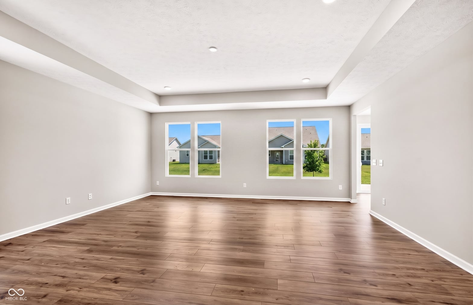 Spacious bright living room with pristine hardwood floors.