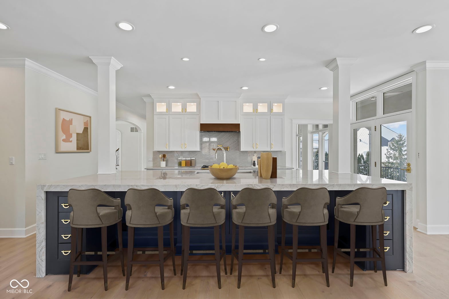 Stunning chef's kitchen with marble island and six-seat bar.