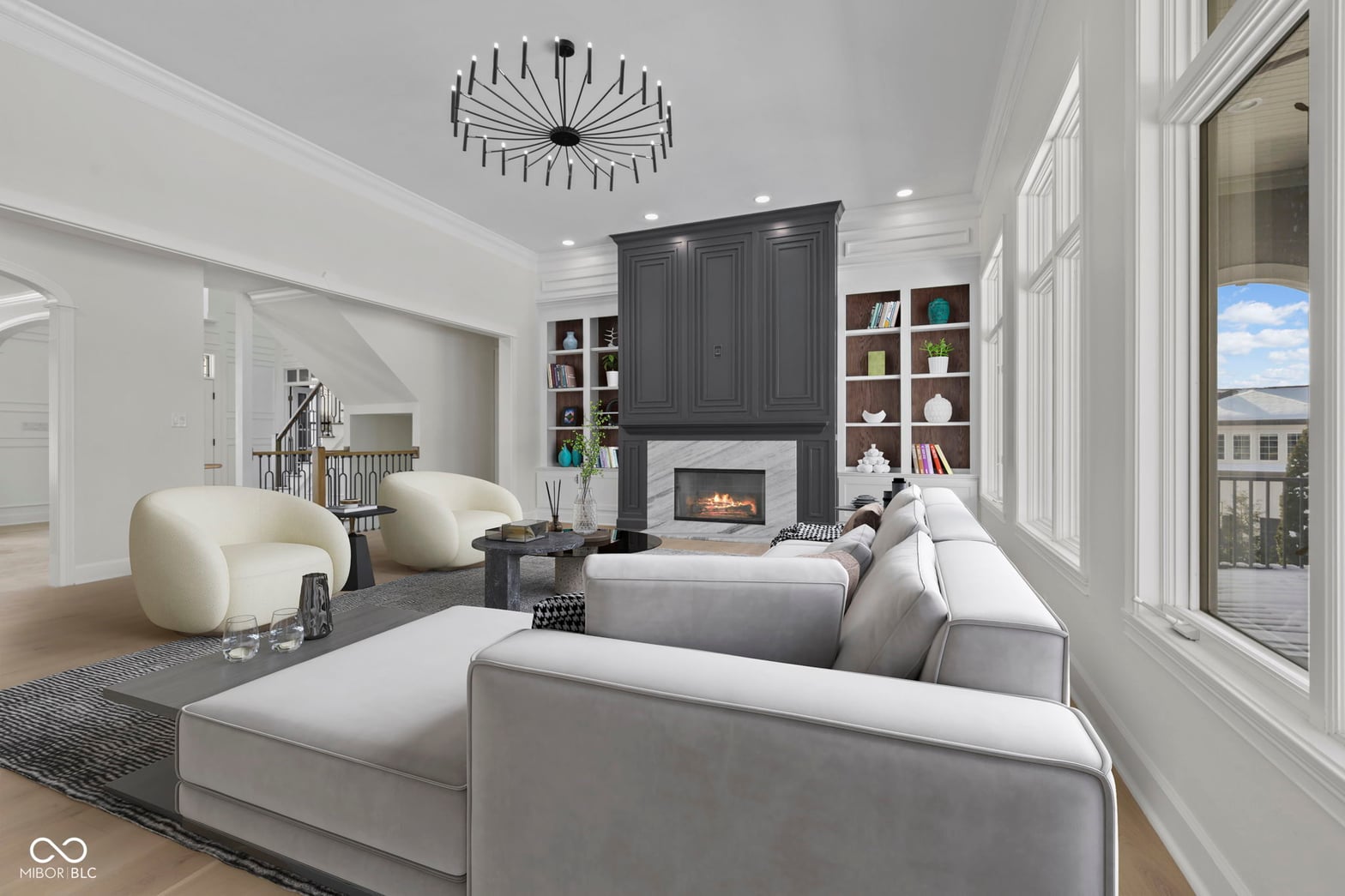 Bright contemporary living room with fireplace and deck views.