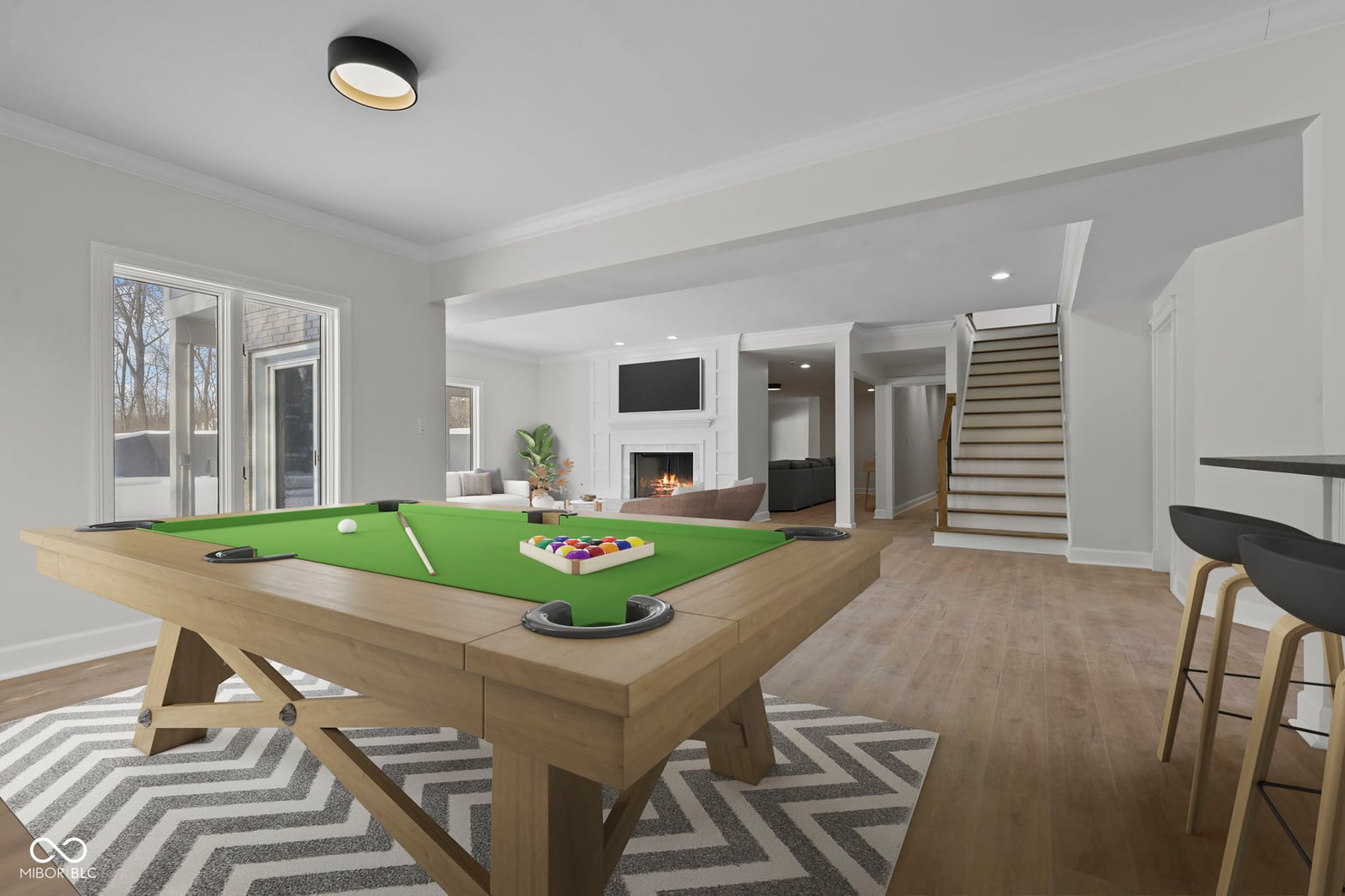 Spacious open-concept entertainment space with pool table.