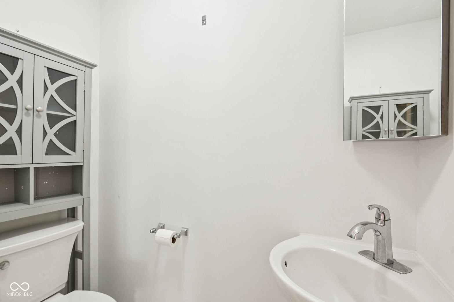 Clean updated bathroom with stylish vessel sink and storage.