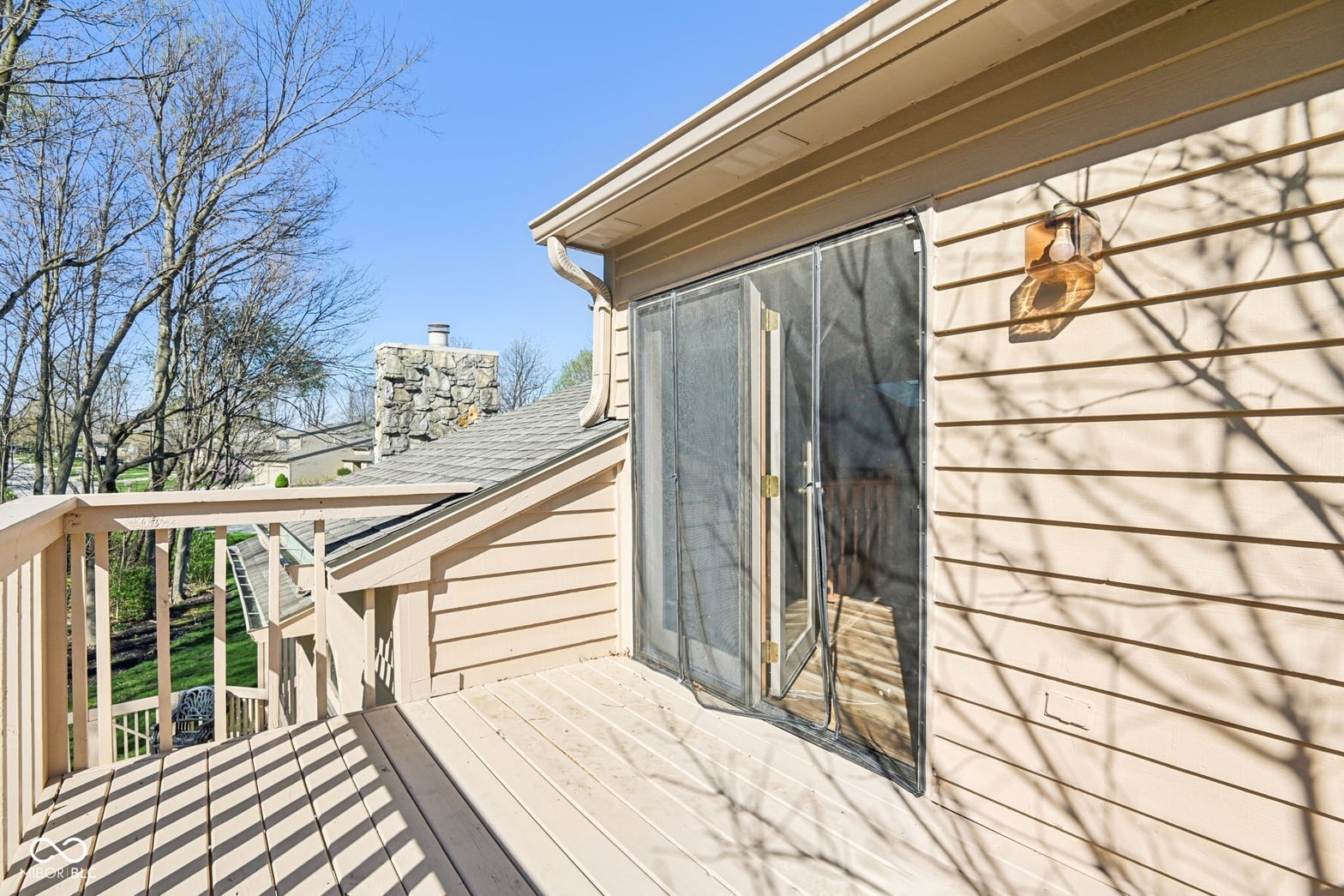 Spacious deck with sliding doors and clear sightlines.