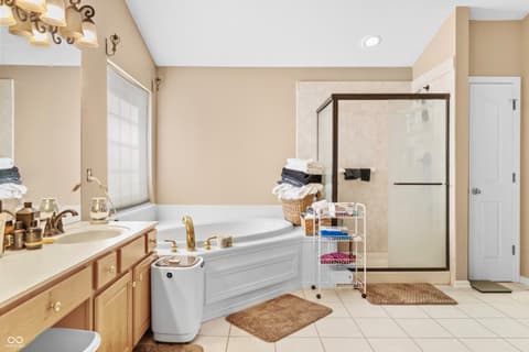 Primary bathroom at 11704 Gray Eagle Drive, Fishers, IN — Spacious primary bath with soaking tub and walk-in shower.
