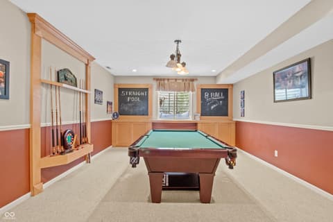 Bonus room at 11704 Gray Eagle Drive, Fishers, IN — Dedicated billiards room with elegant wood finishes.