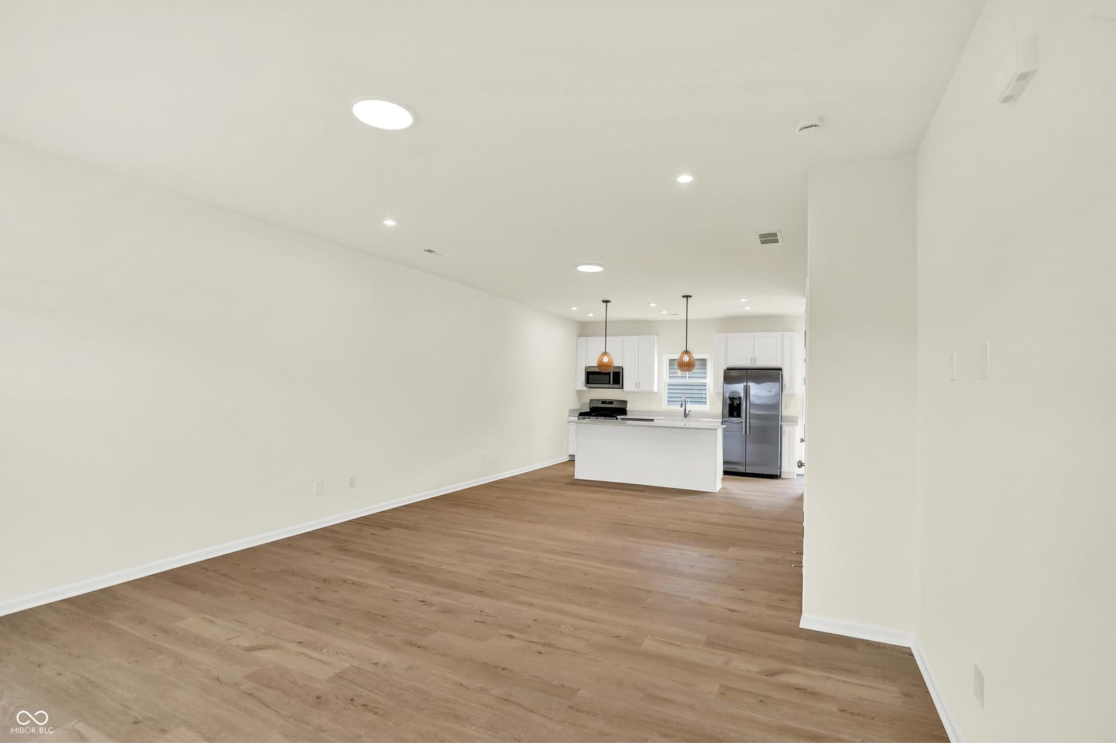 Bright open-concept living with modern kitchen and hardwood floors.