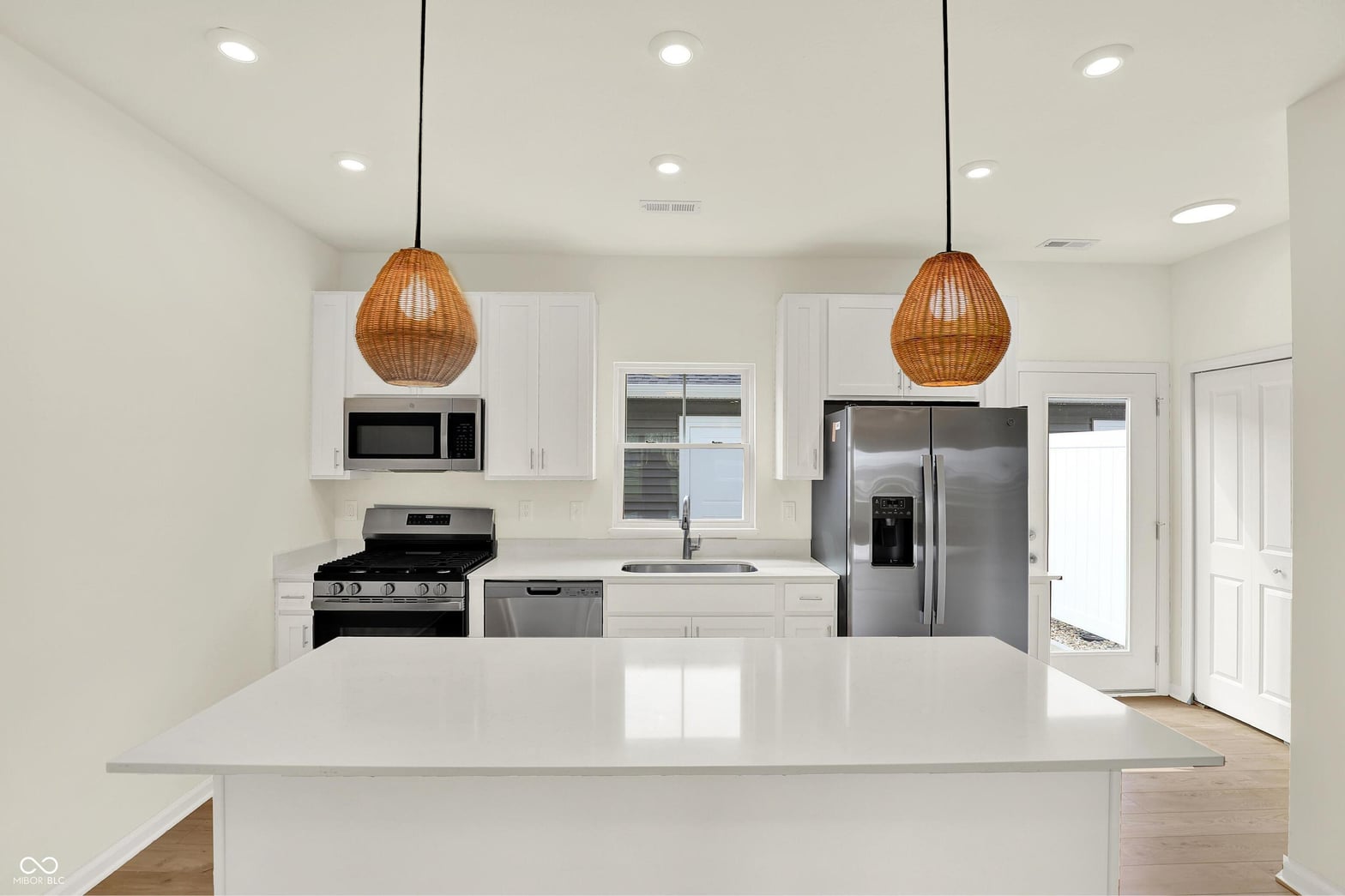 Bright modern kitchen with premium stainless appliances and island.
