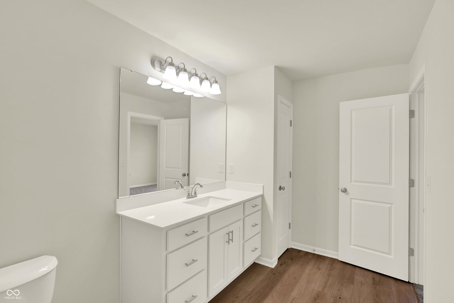 Spacious primary bath with dual vanity and modern finishes.